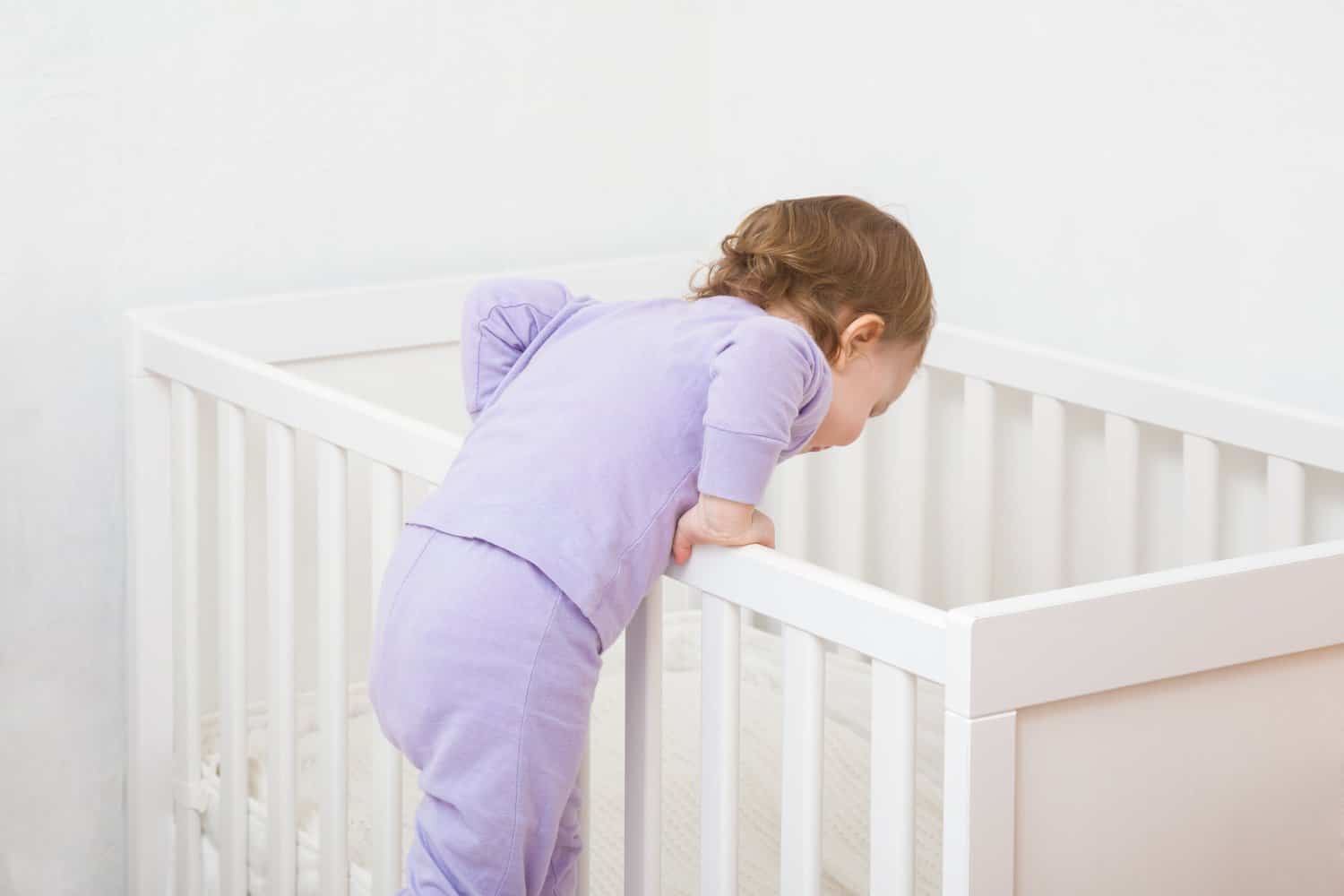 Baby climbing out of a cot